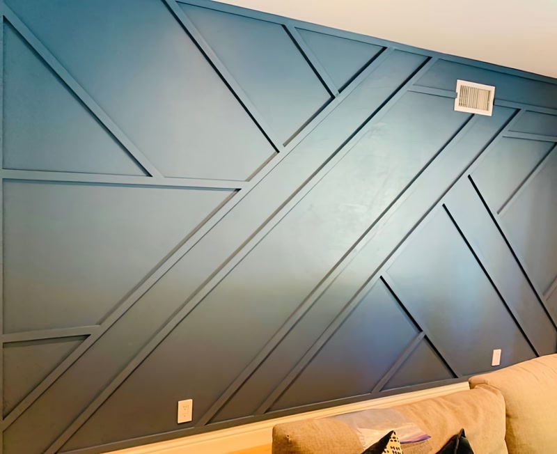 Perete din living amenajat cu profile din poliuretan P851350 într-un model geometric modern albastru.