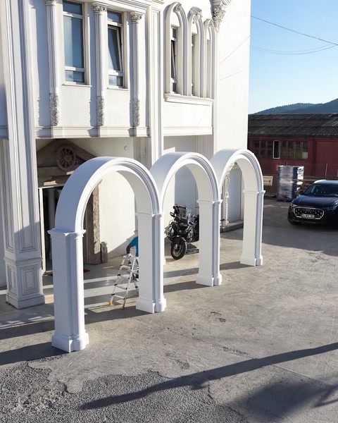 Arce și coloane montate la fațada clădirii albe