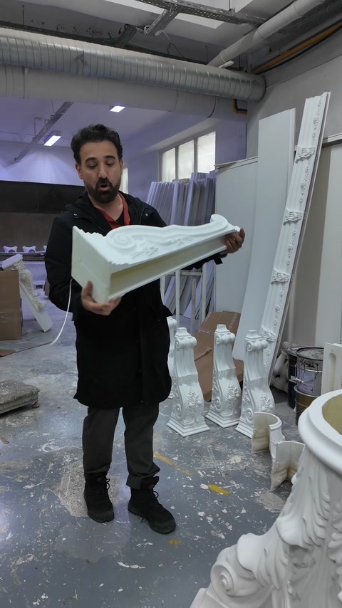 Bărbat ține un capitel curbat cu model acantus