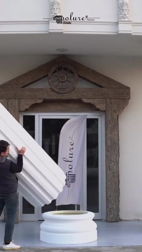 Montatorul aduce un segment canelat lângă intrarea clădirii