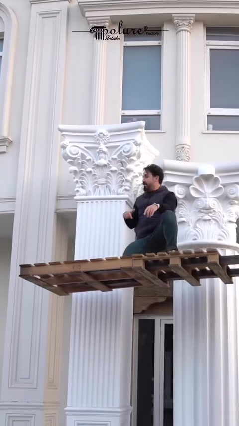 Fațada este încadrată de coloane albe cu capiteluri corintice