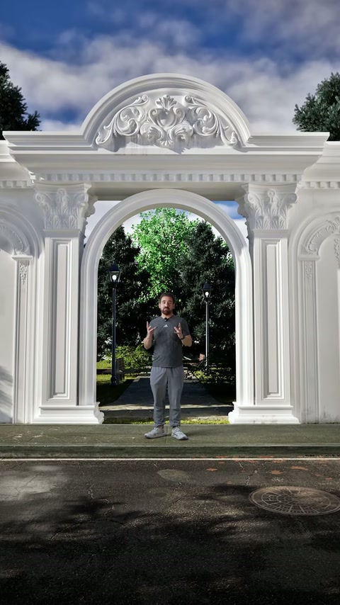Prezentatorul explică portalul finalizat, încadrat de coloane și ornamente sculptate