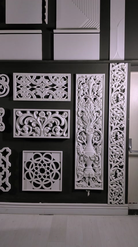 Panouri traforate și ornamente albe expuse în atelier